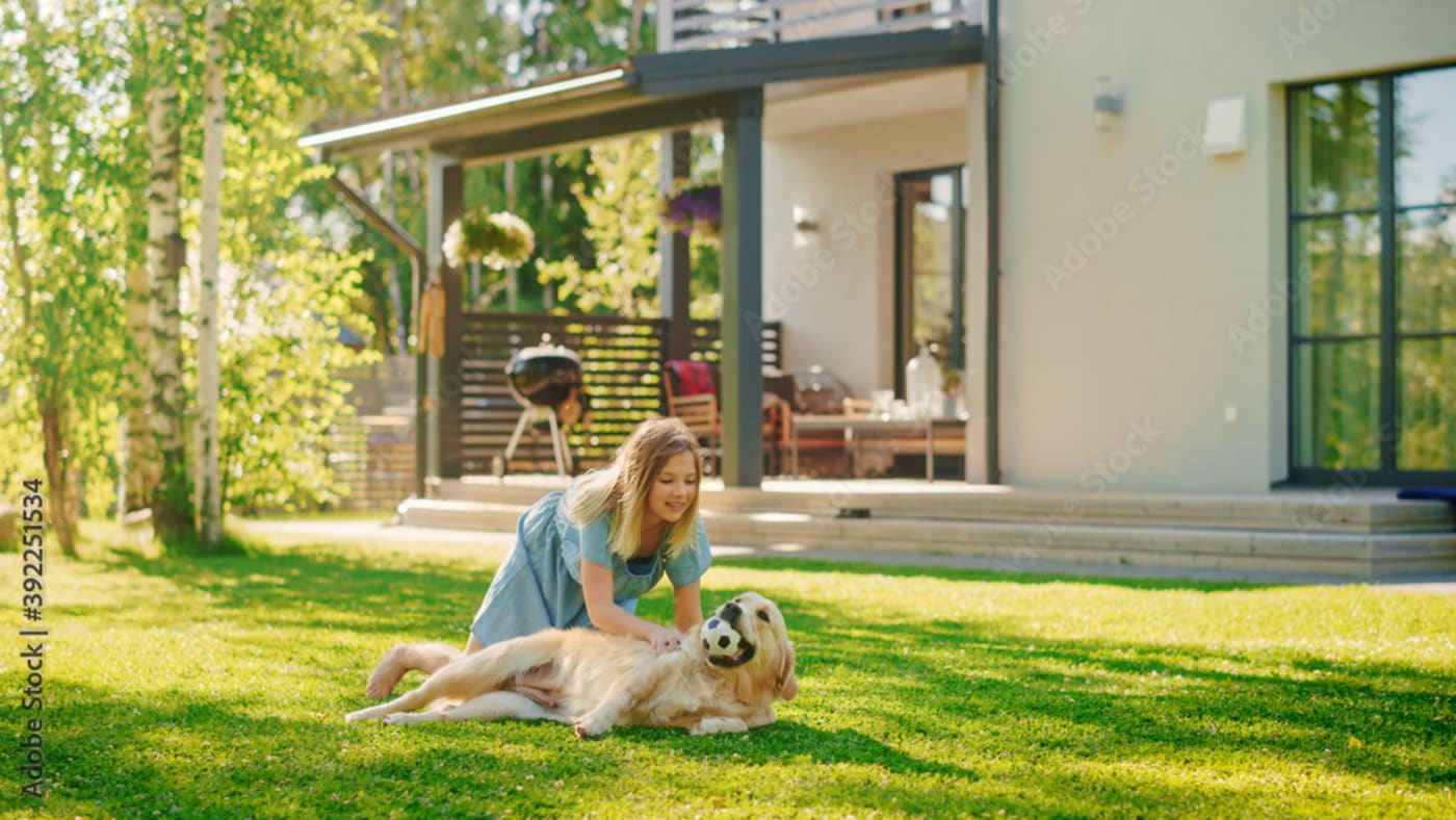 Girl playing with her dog outside