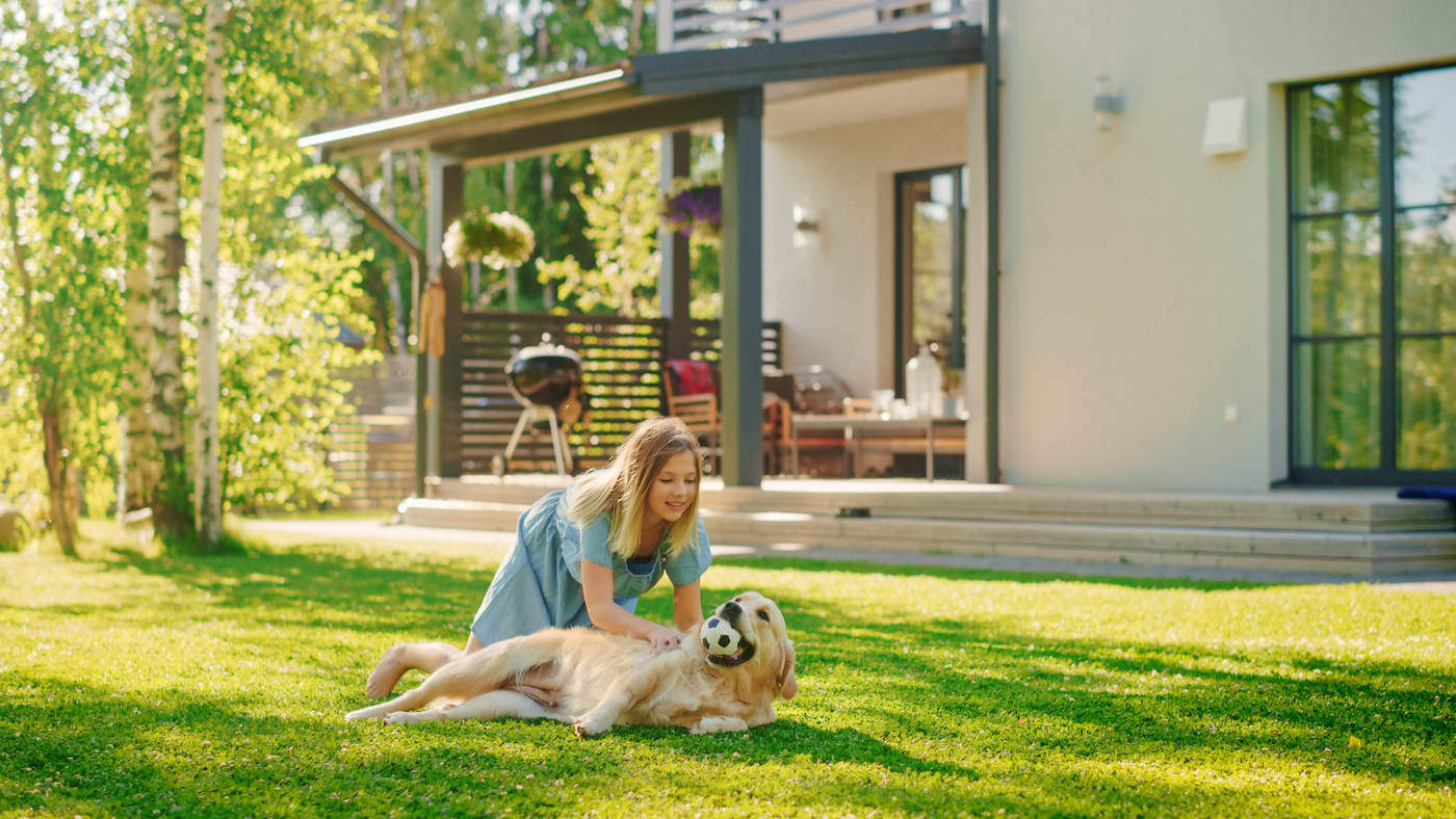  Girl petting her dog outside 